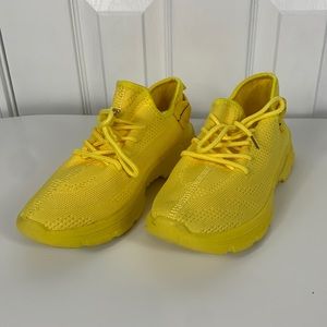 HY bright yellow athletic shoe size U.S. 7, Euro 40.